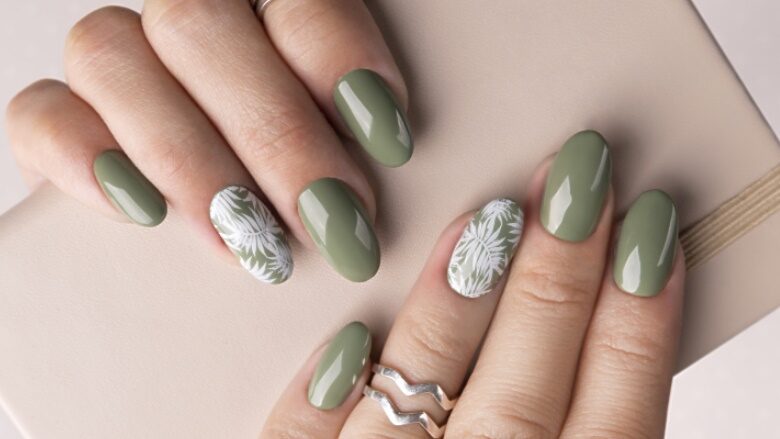 Beautiful womans hands with spring summer floral nail design